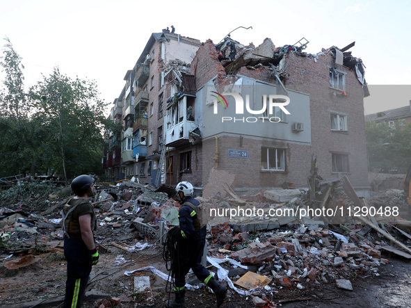 Rescuers are removing the rubble at a block of flats damaged by the overnight Russian missile attack in the Novobavarskyi district of Kharki...