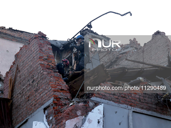 Rescuers are removing the rubble at a block of flats damaged by the overnight Russian missile attack in the Novobavarskyi district of Kharki...