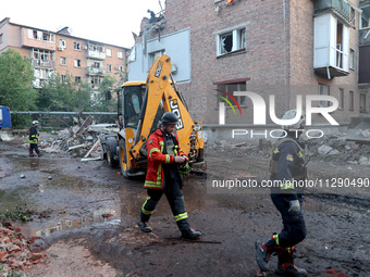 Rescuers are removing the rubble at a block of flats damaged by the overnight Russian missile attack in the Novobavarskyi district of Kharki...