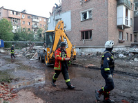 Rescuers are removing the rubble at a block of flats damaged by the overnight Russian missile attack in the Novobavarskyi district of Kharki...