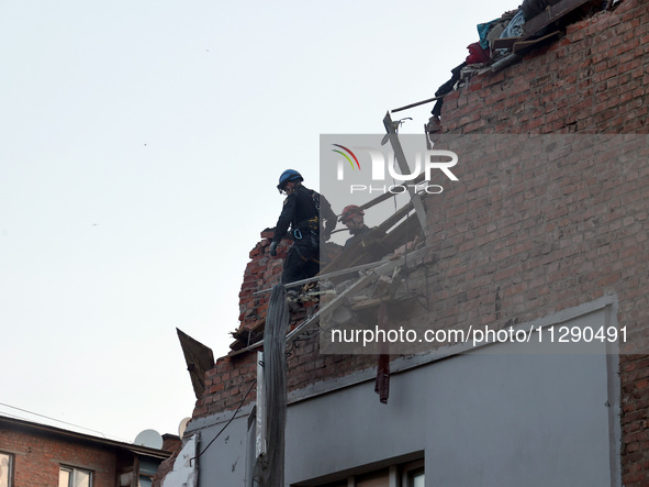 Rescuers are removing the rubble at a block of flats damaged by the overnight Russian missile attack in the Novobavarskyi district of Kharki...