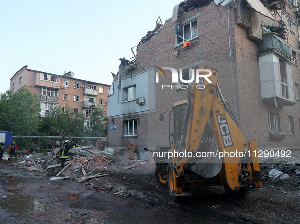 Rescuers are removing the rubble at a block of flats damaged by the overnight Russian missile attack in the Novobavarskyi district of Kharki...