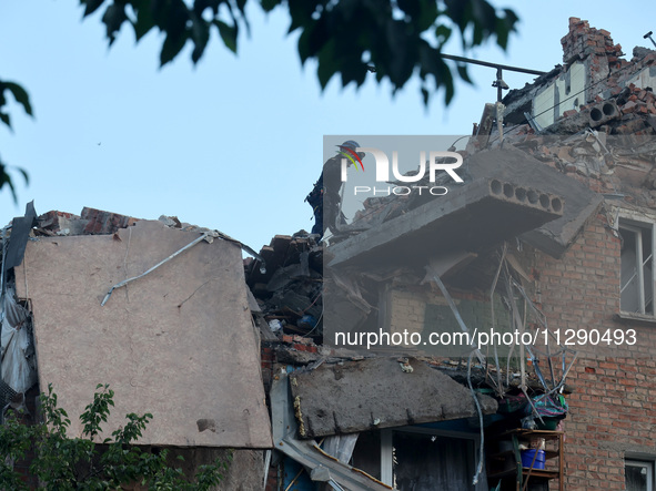 A rescuer is removing the rubble at a block of flats damaged by the overnight Russian missile attack in the Novobavarskyi district of Kharki...