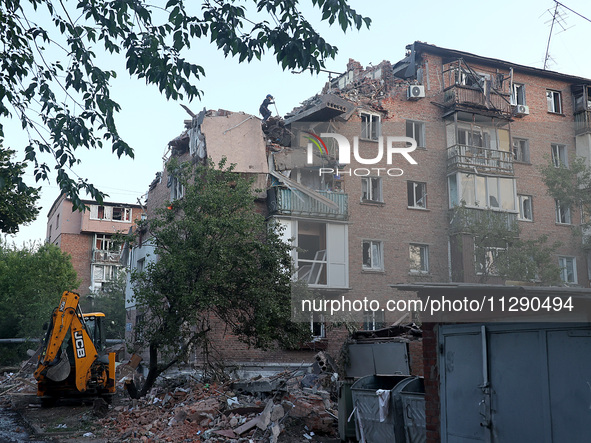 A rescuer is removing the rubble at a block of flats damaged by the overnight Russian missile attack in the Novobavarskyi district of Kharki...