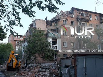 A rescuer is removing the rubble at a block of flats damaged by the overnight Russian missile attack in the Novobavarskyi district of Kharki...