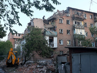 A rescuer is removing the rubble at a block of flats damaged by the overnight Russian missile attack in the Novobavarskyi district of Kharki...