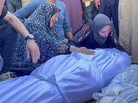 Mourners are reacting next to the bodies of Palestinians killed in an Israeli strike, amid the ongoing conflict between Israel and the Pales...