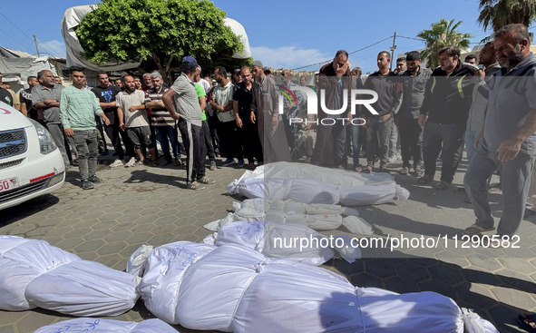 Mourners are gathering next to the bodies of Palestinians killed in an Israeli strike, amid the ongoing conflict between Israel and the Pale...