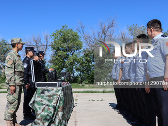 Border police are explaining the types of drones in Altay, Xinjiang province, China, on May 31, 2024. (