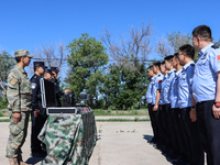 Border police are explaining the types of drones in Altay, Xinjiang province, China, on May 31, 2024. (