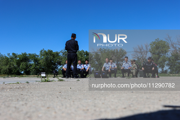 Border police are explaining the types of drones in Altay, Xinjiang province, China, on May 31, 2024. 