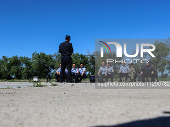 Border police are explaining the types of drones in Altay, Xinjiang province, China, on May 31, 2024. (