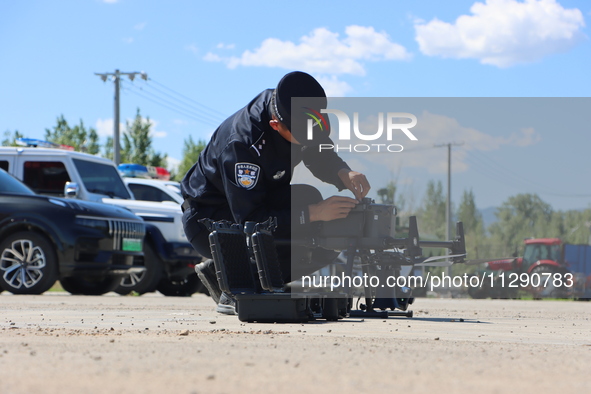 A border police officer is explaining the precautions during a drone flight in Altay, Xinjiang province, China, on May 31, 2024. 