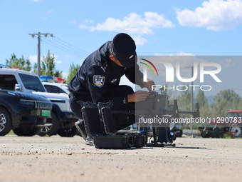 A border police officer is explaining the precautions during a drone flight in Altay, Xinjiang province, China, on May 31, 2024. (