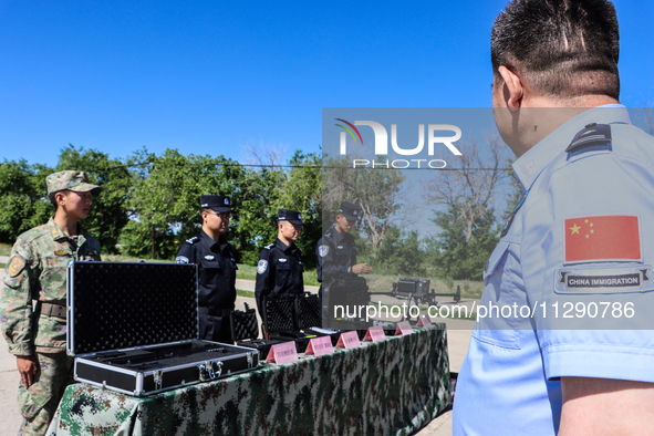 Border police are explaining the types of drones in Altay, Xinjiang province, China, on May 31, 2024. 