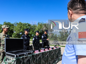 Border police are explaining the types of drones in Altay, Xinjiang province, China, on May 31, 2024. (