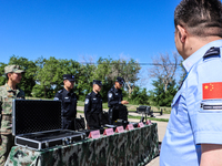 Border police are explaining the types of drones in Altay, Xinjiang province, China, on May 31, 2024. (