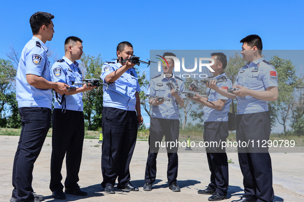 Border police officers are taking turns to experience a police drone flight practice in Altay, Xinjiang province, China, on May 31, 2024. 