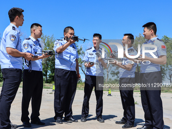 Border police officers are taking turns to experience a police drone flight practice in Altay, Xinjiang province, China, on May 31, 2024. (