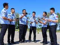 Border police officers are taking turns to experience a police drone flight practice in Altay, Xinjiang province, China, on May 31, 2024. (