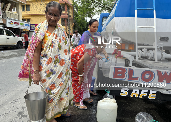 Residents are queuing up to collect drinking water provided by PHE water supply tanks in Siliguri, India, on May 31, 2024. The entire area,...