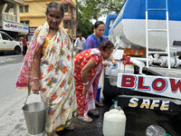 Residents are queuing up to collect drinking water provided by PHE water supply tanks in Siliguri, India, on May 31, 2024. The entire area,...