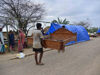 Flood-affected villagers are staying in their makeshift camp on a road after the landfall of cyclone 'Remal' in Nagaon district of Assam, In...