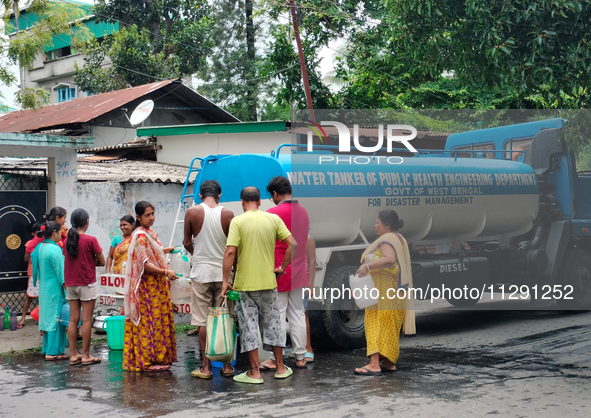 Residents are queuing up to collect drinking water from the drinking water tank in Siliguri, India, on May 31, 2024. The entire area, includ...