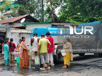 Residents are queuing up to collect drinking water from the drinking water tank in Siliguri, India, on May 31, 2024. The entire area, includ...