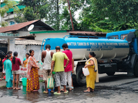 Residents are queuing up to collect drinking water from the drinking water tank in Siliguri, India, on May 31, 2024. The entire area, includ...