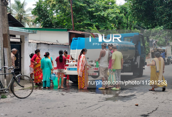 Residents are queuing up to collect drinking water from the drinking water tank in Siliguri, India, on May 31, 2024. The entire area, includ...