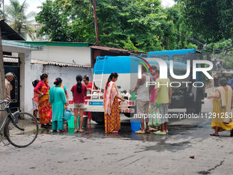 Residents are queuing up to collect drinking water from the drinking water tank in Siliguri, India, on May 31, 2024. The entire area, includ...