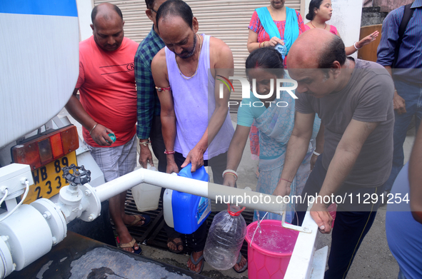 Residents are queuing up to collect drinking water from the drinking water tank in Siliguri, India, on May 31, 2024. The entire area, includ...