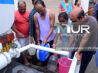 Residents are queuing up to collect drinking water from the drinking water tank in Siliguri, India, on May 31, 2024. The entire area, includ...