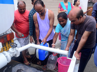 Residents are queuing up to collect drinking water from the drinking water tank in Siliguri, India, on May 31, 2024. The entire area, includ...