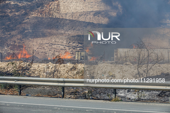 Flames are being seen inside a private property area in Limassol, Cyprus, on May 31, 2024. Some buildings are being endangered after a fire...