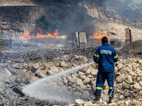 A firefighter is trying to put out the fire in Limassol, Cyprus, on May 31, 2024. Some buildings are in danger after a fire breaks out in th...