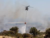 A helicopter is operating during the fire in Limassol, Cyprus, on May 31, 2024. Some buildings are in danger after a fire breaks out in the...