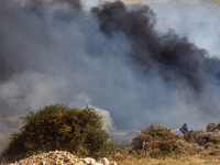 A fireman is trying to put out the flames in Limassol, Cyprus, on May 31, 2024. Some buildings are in danger after a fire breaks out in the...