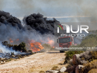 Firemen are preparing to fight the flames in Limassol, Cyprus, on May 31, 2024. Some buildings are in danger after a fire breaks out in the...