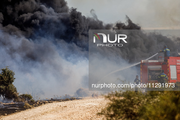 Firemen are operating in the area in Limassol, Cyprus, on May 31, 2024. Some buildings are in danger after a fire breaks out in the Agios Si...