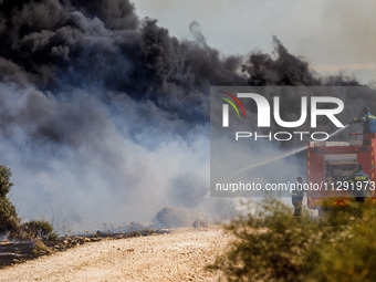 Firemen are operating in the area in Limassol, Cyprus, on May 31, 2024. Some buildings are in danger after a fire breaks out in the Agios Si...