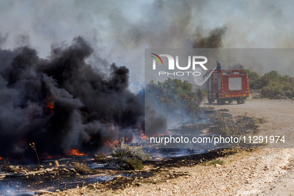 Firemen are operating in the area in Limassol, Cyprus, on May 31, 2024. Some buildings are in danger after a fire breaks out in the Agios Si...