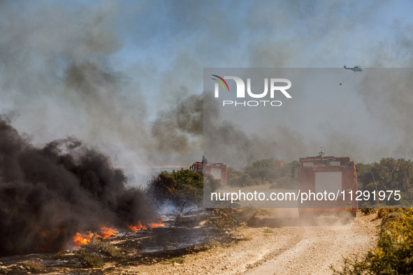 Firemen are operating in the area in Limassol, Cyprus, on May 31, 2024. Some buildings are in danger after a fire breaks out in the Agios Si...