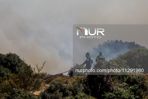 Firemen are operating in the area in Limassol, Cyprus, on May 31, 2024. Some buildings are in danger after a fire breaks out in the Agios Si...