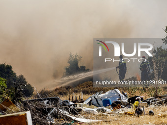 Firemen are operating in the area in Limassol, Cyprus, on May 31, 2024. Some buildings are in danger after a fire breaks out in the Agios Si...