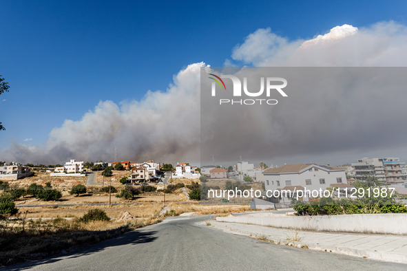 Smoke is being seen in the distance behind the inhabited area in Limassol, Cyprus, on May 31, 2024. Some buildings are being endangered afte...