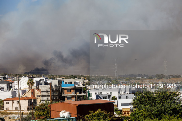 Smoke is being seen in the distance behind the inhabited area in Limassol, Cyprus, on May 31, 2024. Some buildings are being endangered afte...