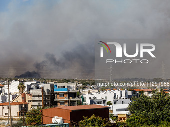 Smoke is being seen in the distance behind the inhabited area in Limassol, Cyprus, on May 31, 2024. Some buildings are being endangered afte...