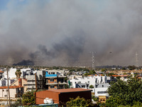 Smoke is being seen in the distance behind the inhabited area in Limassol, Cyprus, on May 31, 2024. Some buildings are being endangered afte...